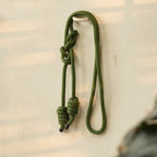 Green rope with a knot on a light background